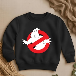 May include: Black sweatshirt featuring the Ghostbusters logo: a white ghost figure inside a red circle with a diagonal red line. The sweatshirt has a crew neck and long sleeves, suitable for casual wear.