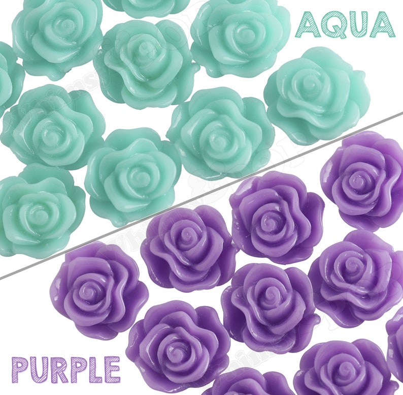 May include: Two rows of plastic rose-shaped embellishments. The top row is aqua blue and the bottom row is purple.