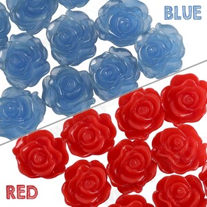 May include: A collection of blue and red rose-shaped resin embellishments. The blue roses are translucent and the red roses are opaque.