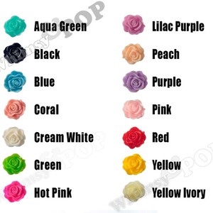 May include: Assortment of 12 colors of rose-shaped resin embellishments. Colors include aqua green, black, blue, coral, cream white, green, hot pink, lilac purple, peach, pink, purple, red, yellow, and yellow ivory.