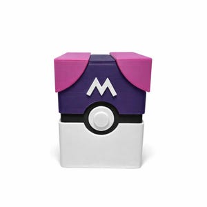 May include: A cube-shaped container with a white base and a black band. The middle section is purple with a white "W" emblem. The top has pink flaps. A white button is centered on the front.