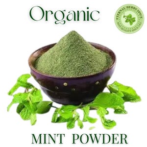 May include: A dark brown bowl filled with green mint powder, with fresh mint leaves around the bowl. The word "Organic" is above the bowl, and "MINT POWDER" is below. A circular logo reads "Eternal Herbs Spice Best Quality Since 1962".