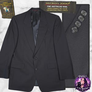 May include: A black blazer with two front pockets and a two-button closure. The blazer has a notched lapel and four buttons on each sleeve cuff. The label reads "MICRON 2000 FINE AUSTRALIAN WOOL".