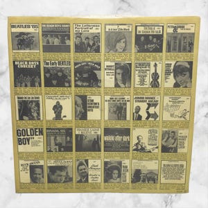 May include: A vintage record album back cover featuring a grid of thirty black and white thumbnail images of various music albums. Each square contains a small photograph of an artist or band, album titles, and descriptive text in black ink.