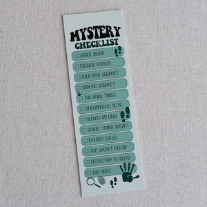 May include: A light blue bookmark with the words "Mystery Checklist" in black and green. The checklist includes phrases like "Serial Killer" and "The Final Twist." Footprints, a magnifying glass, and a handprint are also featured.
