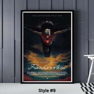 May include: Framed movie poster for "Frankenstein" by Guillermo del Toro. The poster features a dark, dramatic image of a figure with a red ribcage and a helmet, with the text "ONLY MONSTERS PLAY GOD" at the top. The movie title is in a stylized font.