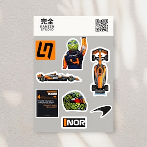 May include: A sticker sheet featuring Formula 1 racing graphics. Includes a race car, a driver in a helmet, and the text "NORRIS RADIO". The stickers are in orange, black, and white.