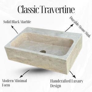 May include: A rectangular, light-colored stone sink with a neutral color palette. The sink has a smooth interior and a textured exterior. The text "Classic Travertine" is at the top. Additional text includes "Solid Black Marble", "Durable Stone Sink", "Modern Minimal Form", and "Handcrafted Luxury Design".