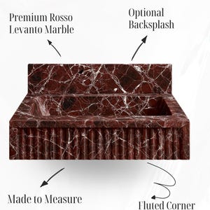Deep red marble wall-mounted basin in Rosso Levanto marble, designed for luxury modern bathrooms.