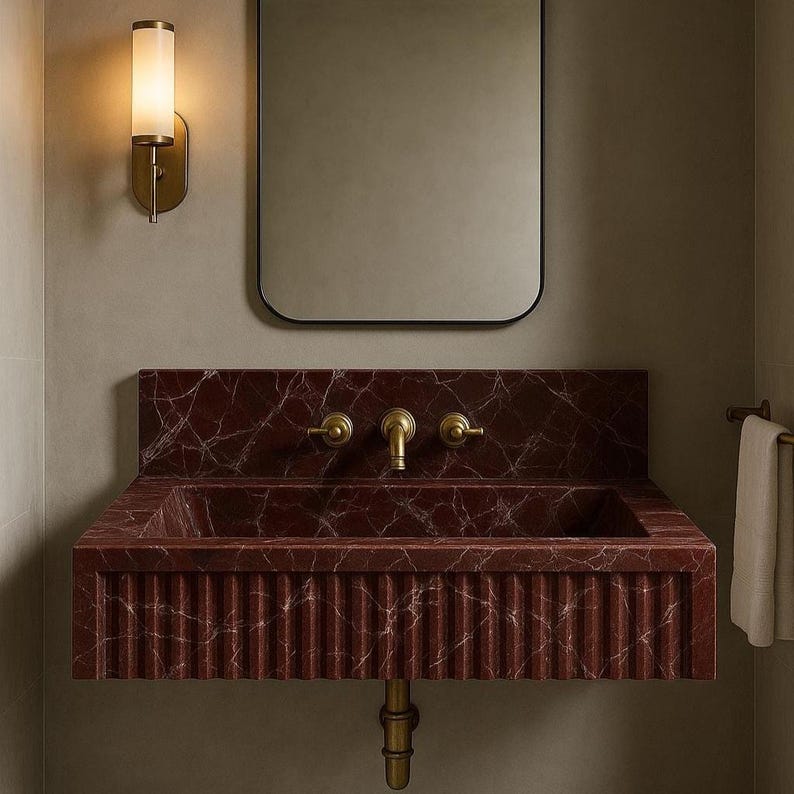 Elegant red marble wall-mounted basin featuring Rosso Levanto stone with fine white veins and artisan craftsmanship.