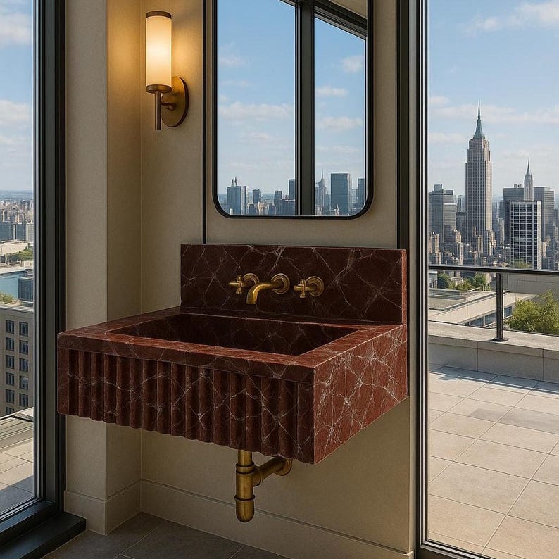 Wall-mounted Rosso Levanto marble basin with integrated backsplash and refined artisan finish.