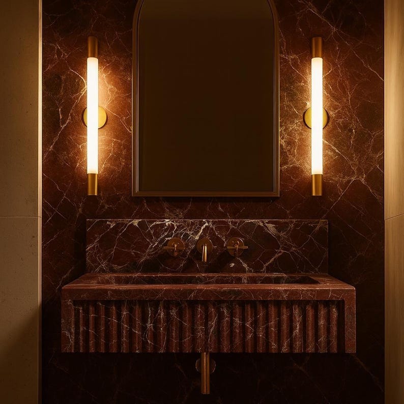 Modern bathroom design featuring Rosso Levanto marble wall sink with sculpted fluted front panel.