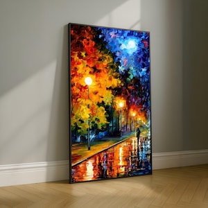 May include: A framed oil painting depicts a nighttime street scene. The artwork features a vibrant color palette of orange, yellow, blue, and purple. Streetlights illuminate a wet, reflective pathway, with a couple walking under an umbrella.
