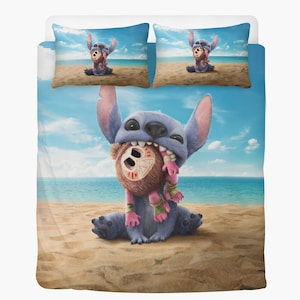 May include: A blue and white bedding set featuring a cartoon character, Stitch, holding a brown teddy bear on a beach. The set includes a duvet cover and two pillowcases. The pillowcases show Stitch and the bear on the beach. The background shows a blue sky and ocean.