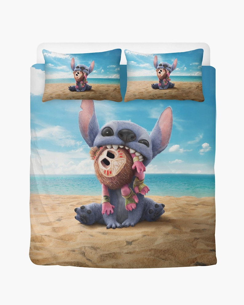 May include: A blue and white bedding set featuring a cartoon character, Stitch, holding a brown teddy bear on a beach. The set includes a duvet cover and two pillowcases. The pillowcases show Stitch and the bear on the beach. The background shows a blue sky and ocean.