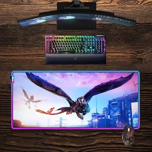 May include: A gaming setup featuring a curved monitor, a backlit keyboard, and a large mousepad with a dragon graphic. A matching mouse is also included. The keyboard has a rainbow color scheme.