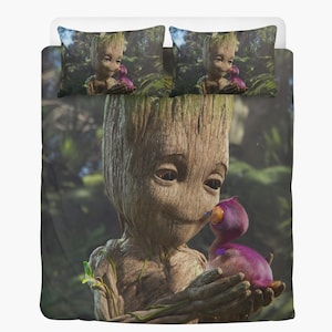 May include: A bedding set featuring a detailed illustration of Groot from Guardians of the Galaxy. The set includes a duvet cover and two pillowcases. Groot is holding a purple creature with an orange beak. The background is a lush green forest.