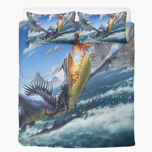 May include: A duvet cover and two pillowcases with a fantasy dragon illustration. The dragons are depicted in blue, yellow, and orange, soaring over water. The background shows a blue sky with clouds and a coastal town.