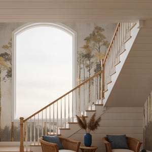 May include: Interior scene featuring a staircase with a wooden banister and white risers. The walls are adorned with a mural of stylized trees in gold and gray tones. Two wicker chairs with blue cushions are placed near the stairs.
