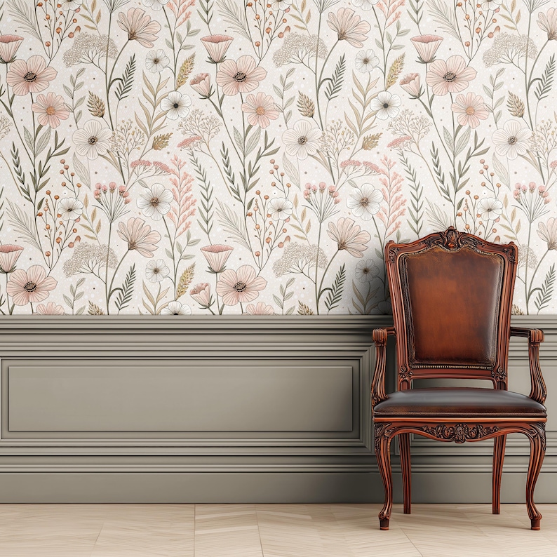 May include: A floral wallpaper featuring a repeating pattern of pink, white, and beige flowers and foliage. Below the wallpaper is a gray paneling and a brown wooden chair with ornate carvings.