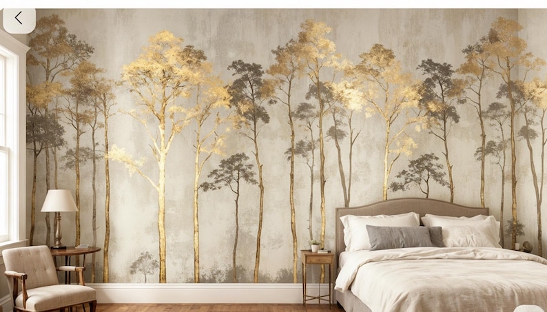 May include: A bedroom with a mural featuring stylized trees in gold and gray tones. The trees have slender trunks and full, textured canopies. The room includes a bed with white bedding, a side table, and a chair.