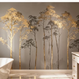 May include: A bathroom with a mural of stylized trees in gold and gray tones. The trees are painted on the wall behind a white bathtub and a marble vanity with gold fixtures. The room has a luxurious and modern aesthetic.