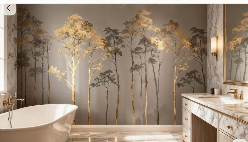 May include: A bathroom with a mural of stylized trees in gold and gray tones. The trees are painted on the wall behind a white bathtub and a marble vanity with gold fixtures. The room has a luxurious and modern aesthetic.