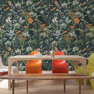 May include: A dining room scene featuring a wooden table and chairs. The chairs are in various colors: white, orange, and yellow. The background is a dark floral wallpaper with butterflies and flowers in shades of orange, white, and green.