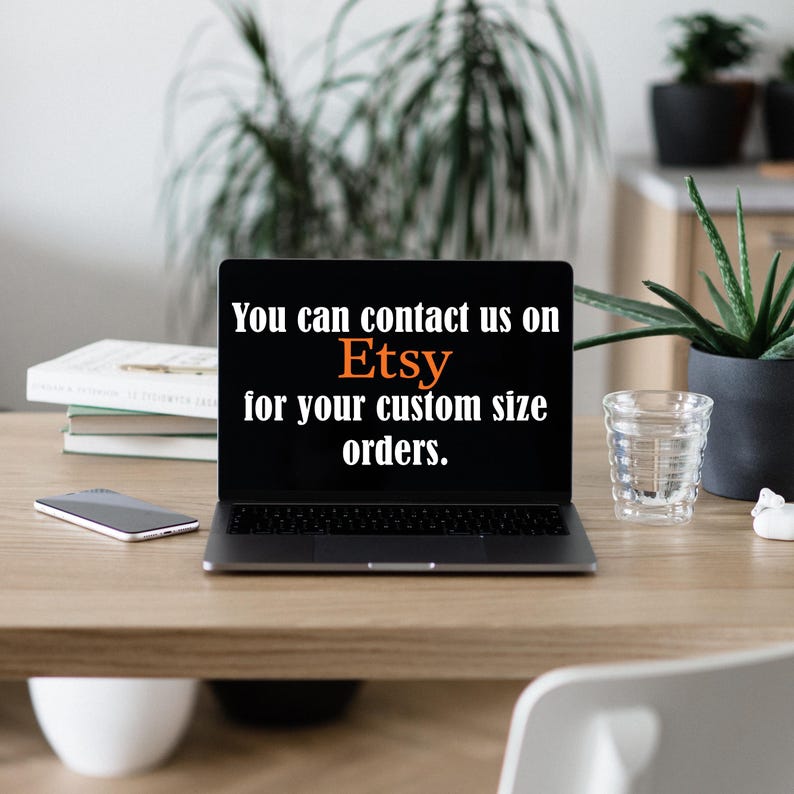 May include: A laptop displaying the Etsy logo and the text "You can contact us on Etsy for your custom size orders." The laptop is on a wooden desk with a smartphone, books, and a glass of water.