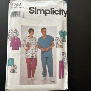 May include: Simplicity pattern 8088. The cover displays images of medical scrubs and jackets in different colours and patterns. The front shows a woman in a white patterned jacket and pink trousers, and a man in blue scrubs.