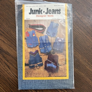 May include: A sewing pattern envelope titled Junk-Jeans Designer Vests featuring illustrations of five different denim vest designs. The packaging includes text indicating adult sizes petite, small, medium, and large, with a copyright date of 1990.