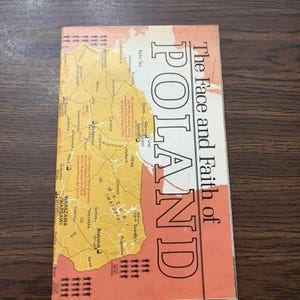 May include: A rectangular vintage map titled The Face and Faith of POLAND, featuring a yellow-toned map of Poland with black text, city names, and geographical details, set against a muted orange background with small black icon illustrations.