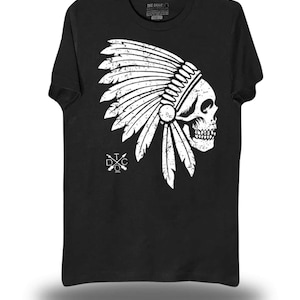 May include: Black t-shirt featuring a white graphic of a skull wearing a Native American headdress. The design includes feathers and the text "THE DRIVE" at the top. A logo with crossed arrows and the letters "DTC" is on the left.