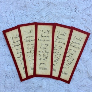 May include: Five red and white bookmarks with the quote "I will honour Christmas in my heart. And try to keep it all year." by Charles Dickens.