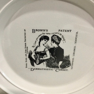 May include: Black and white illustration of two women wearing corsets. The text reads "Brown's Patent "I see you wear the same corsets as myself." Elegance, Comfort, Durability. "Dermathistic" Corset. Bones, Busk, and Side Steels Protected by Leather."