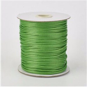 May include: A spool of bright green waxed cotton cord. The cord is wound tightly around a white cardboard spool.