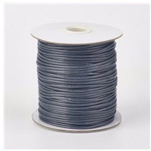 May include: A spool of dark gray waxed cotton cord. The cord is wound around a white cardboard spool.