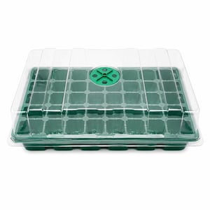 May include: A rectangular green plastic seed starting tray with multiple individual cells for planting. The tray is covered by a clear, transparent plastic dome lid that features a circular green adjustable ventilation dial on the top center.