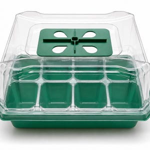 May include: A green plastic seed starter tray with twelve individual compartments and a clear, vented plastic dome lid. The lid features a dark green adjustable ventilation slider with four oval-shaped openings for airflow control.
