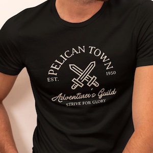 Stardew Valley Shirt | Pelican Town Adventurers Guild Tee | Retro Gaming Gift | Cozy Gamer Tee | Stardew Valley Fan Gift Bild 1