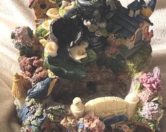 A nature loving statue with a bird and flower theme. (Read Description)