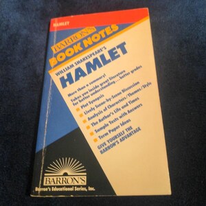 May include: A paperback book titled "BARRON'S BOOK NOTES HAMLET" by William Shakespeare. The cover is a mix of red, white, blue, and yellow. The book includes plot synopsis, scene discussions, character analysis, and sample tests.