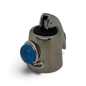 May include: A silver-toned metal bottle stopper featuring a hinged locking mechanism and a black rubber seal. The exterior is decorated with a circular, translucent blue glass cabochon held in place by a decorative silver wire wrap design.