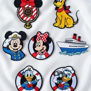 May include: A selection of embroidered Disney character patches with a nautical theme. Featuring Mickey and Minnie Mouse, Donald and Daisy Duck, and Pluto. Designs include life rings, a ship's wheel, and a cruise ship, with bright colours and detailed stitching.