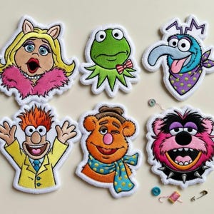 May include: A set of three ceramic mugs with a speckled, matte finish. The mugs are in shades of cream, light gray, and dark gray. Each mug has a simple, minimalist design, perfect for coffee or tea.