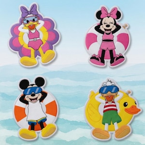 May include: Four embroidered patches featuring Disney characters in swimwear. Daisy Duck is in a pink swimsuit and sunglasses, surrounded by a flower-shaped float. Minnie Mouse is in a pink swimsuit and shorts, with a pink and white float. Mickey Mouse is in swim trunks and goggles, with an orange and white float. Donald Duck is in swim trunks and goggles, on a yellow duck float.