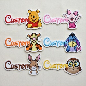 May include: Embroidered patches featuring beloved cartoon characters, including Winnie the Pooh, Piglet, Tigger, Eeyore, Rabbit, and Owl. Each patch has the word "Custom" in a matching color.