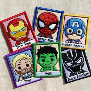 May include: Six rectangular embroidered patches featuring cartoon-style superhero characters: Iron Man, Spider-Man, Captain America, Thor, Hulk, and Black Panther. Each patch has a colored border and a white label at the bottom with the character name.