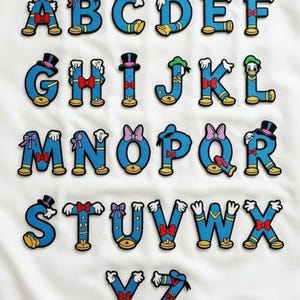 Pode incluir: Um alfabeto completo de patches bordados azuis, cada um em forma de letra. As letras são decoradas com elementos de personagens de desenhos animados, incluindo chapéus, laços e luvas. Os patches estão em um fundo branco.