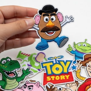 May include: Embroidered patch of Mr. Potato Head from Toy Story, with a brown head, black hat, and blue trousers. Other character patches include Buzz Lightyear, Rex the dinosaur, and the Toy Story logo.